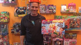 Bang Zoom Design Co-founder Mike Hoeting sports one of the holiday season's popular games - Chow Crown - in his Cincinnati showroom.