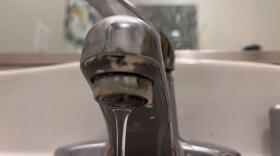 Water flows from a faucet.