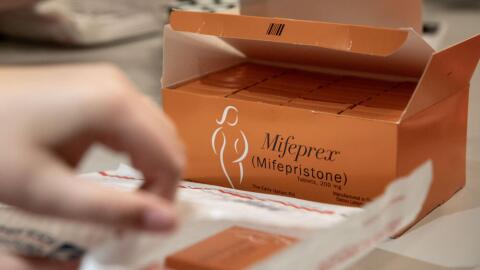 Volunteers pack envelopes with mifepristone and information in Massachusetts in 2025. (Robin Lubbock/WBUR, File)