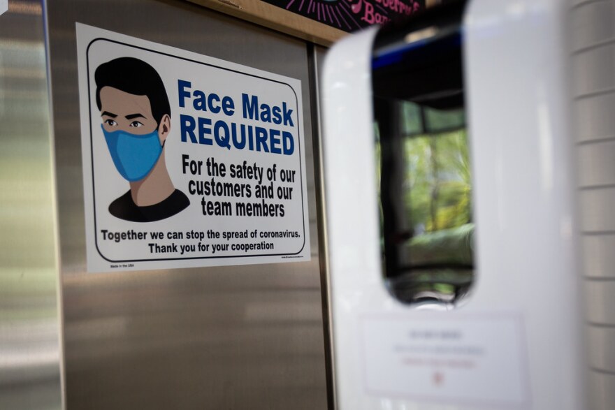 A sign requiring face masks is posted at Cappy's Cafe on the UT Austin campus on Aug. 21.