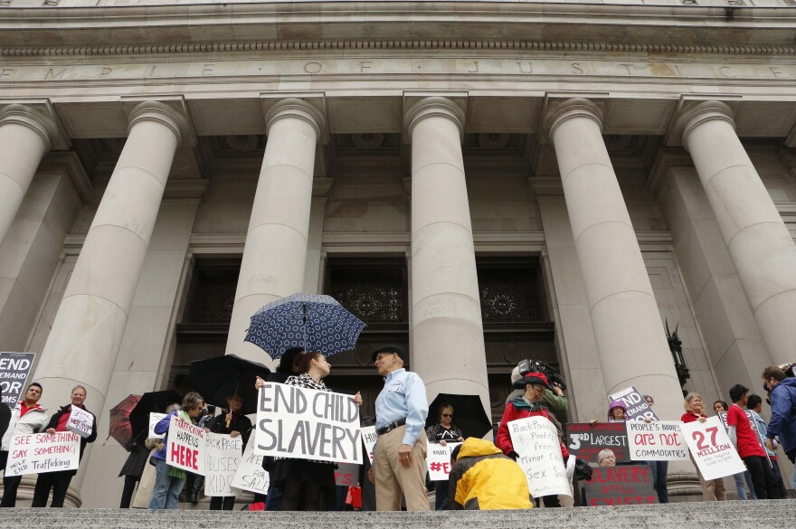 People rally in 2014 at the Washington state Supreme Court, which heard a case filed by three victims of sex trafficking against Backpage.com, saying the website helped promote the exploitation of children.