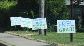 Signs in English and Spanish near a COVID-19 testing site in Goshen, Indiana.