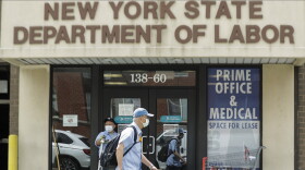 Pedestrians pass the New York State Department of Labor office.