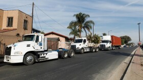 Commercial trucks line up in front of a residential neighborhood in the Wilmington area of Los Angeles on Dec. 2, 2024. California has withdrawn its clean-air rule phasing out diesel trucks.