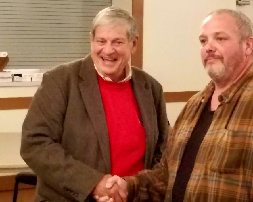 John Barrett (left) poses for a photo with a supporter after winning a special election for state representative. 