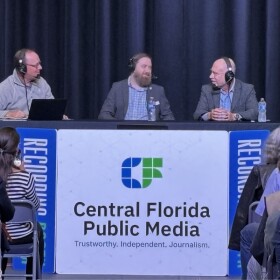 WLRN's Tom Hudson (left), host of The Florida Roundup, on stage with Central Florida Public Media's Brendan Byrne (center) and Greg Autry, Space Czar for the University of Central Florida (left) during a live broadcast with an audience at the Central Florida Public Media studios on February 27, 2026. 