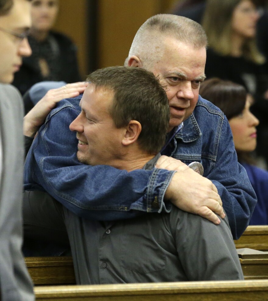 Tim Ward (top), who lost his wife Brandy in a 2014 landslide in Oso, hugs Dayn Brunner, who lost his sister, Summer Raffo, as Ward arrives for a session of King County Superior Court, Monday, Oct. 10, 2016, in Seattle. 