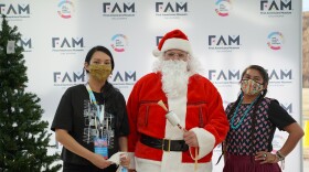 Indigenous Santa poses with two attendees of the First Americans Museum 2021 Winter Art Market. He's back for the 2023 event at FAM this weekend.
