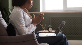A woman participates in a telehealth appointment.