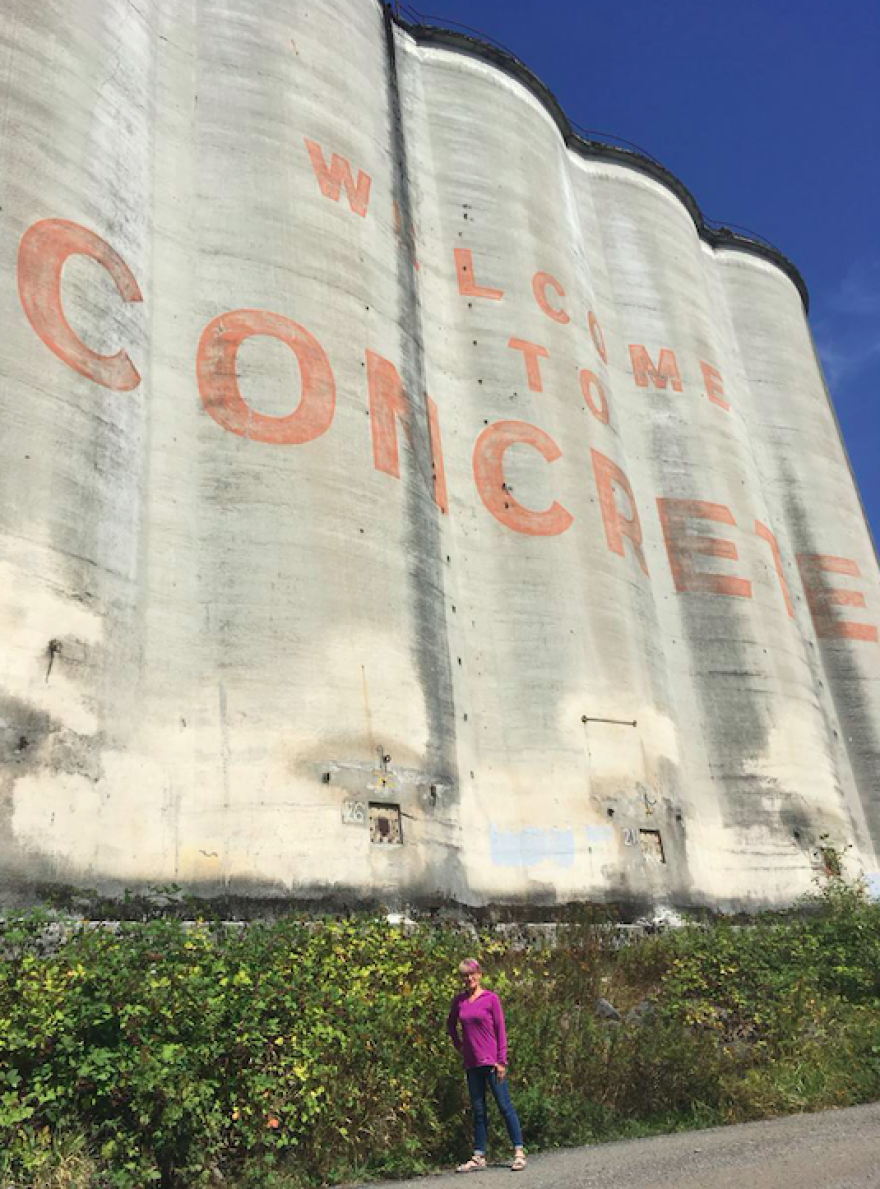 Valerie Stafford in front of the cement silos in Concrete, which were painted by the Warner Brothers crew for the filming of "This Boy's Life."