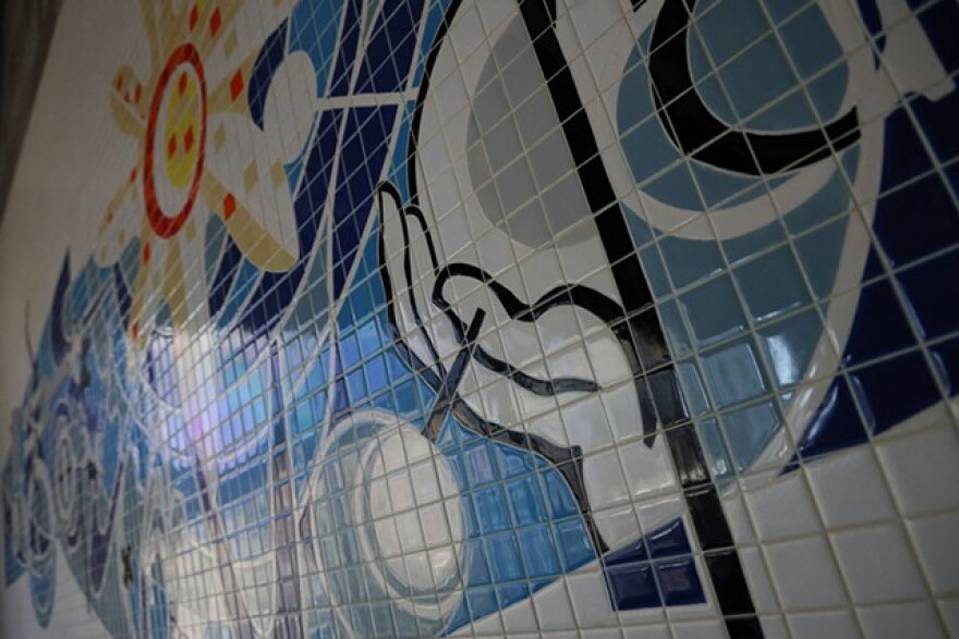 The mosaic at first glance looks like a painting. But each fleck of color was cut by hand and installed. Some flecks are as small as a pip on a die.