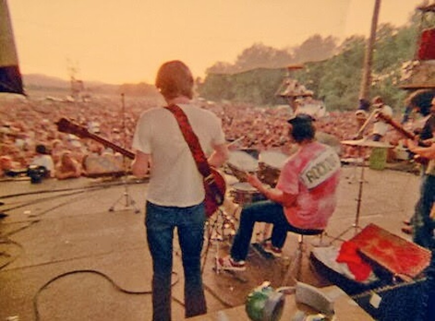 As the sun begins to set on the massive crowd in Veneta, the Grateful Dead starts a 31- minute rendition of their song, Dark Star.