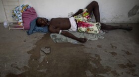 A man suffering from cholera symptoms lies on the floor of the hospital in Marchand Dessalines, Haiti.