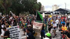 protestors march and hold signs