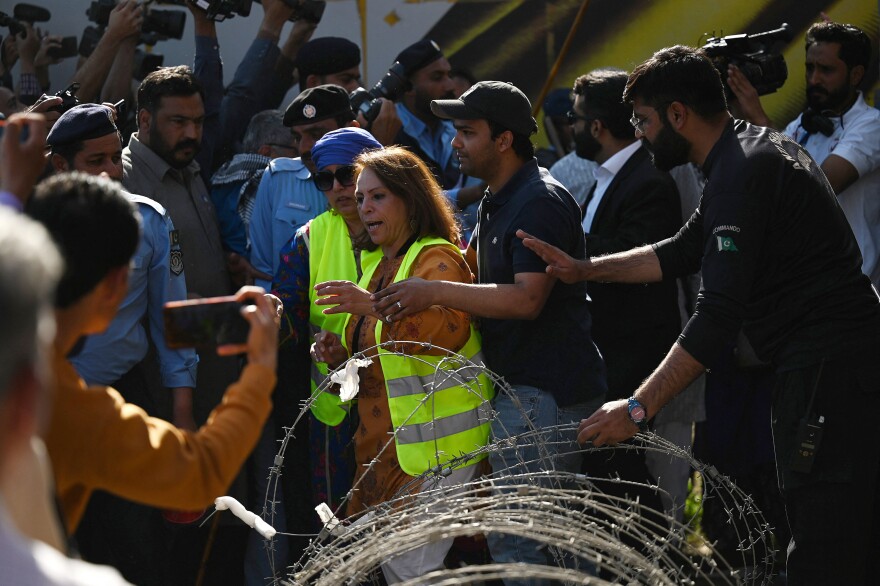 Policemen try to stop activists during a rally to mark International Women's Day in Islamabad on March 8 — and demand equal rights for women in Pakistan. Thousands of women took part in rallies across the country despite efforts by authorities in several cities to block the marches.