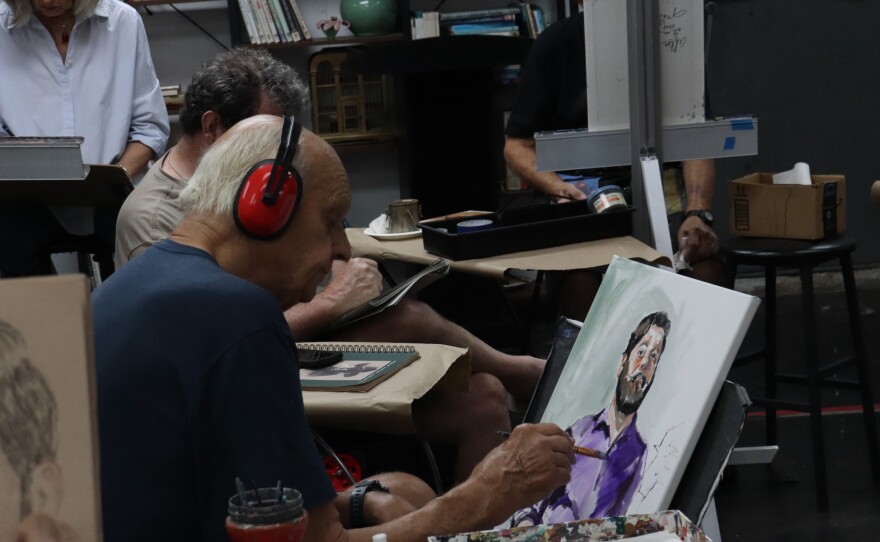 Fritz Schumacher paints a portrait of Derek Galvan during a June 24 session at the Art Center of Corpus Christi.