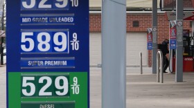 Gas prices are displayed as a man checks gas prices before he fills up his vehicle's gas tank at a gas station in Chicago, Wednesday, March 25, 2026. (AP Photo/Nam Y. Huh)