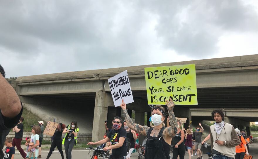 demonstrators marching down washtenaw avenue with signs