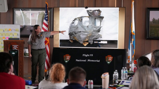 U.S. Park Ranger Betsy Keene, curator of National Parks of Western Pennsylvania, explains a slide showing a damaged part of United Flight 93 during an educators seminar at the Flight 93 National Memorial in Shanksville, Pa., Tuesday, June 23, 2026.