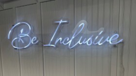 A "Be Inclusive" sign hangs at the home of PA Inclusive and Coffee Inclusive in Pittston.