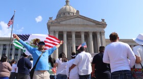 Oklahoma City resident Mauricio Fonseca holds a blended Mexican and American flag in the air during a protest against HB 4156 on May 15 outside the Oklahoma State Capitol.