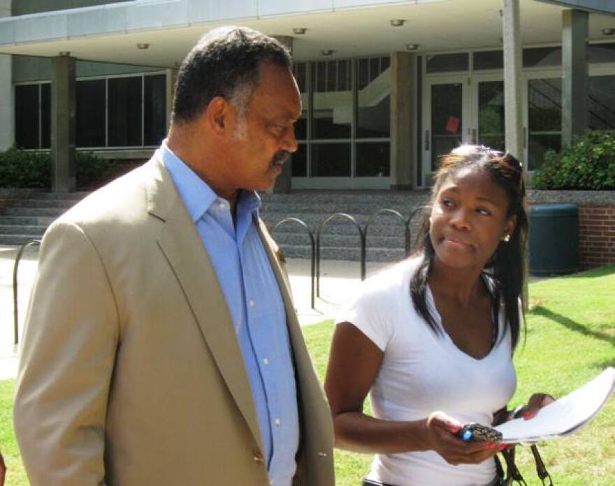 The Rev. Jesse Jackson speaks with a Michigan State University student during a trip to the campus Wednesday. He came to urge students to attend a civil rights march Aug. 28 in Detroit.