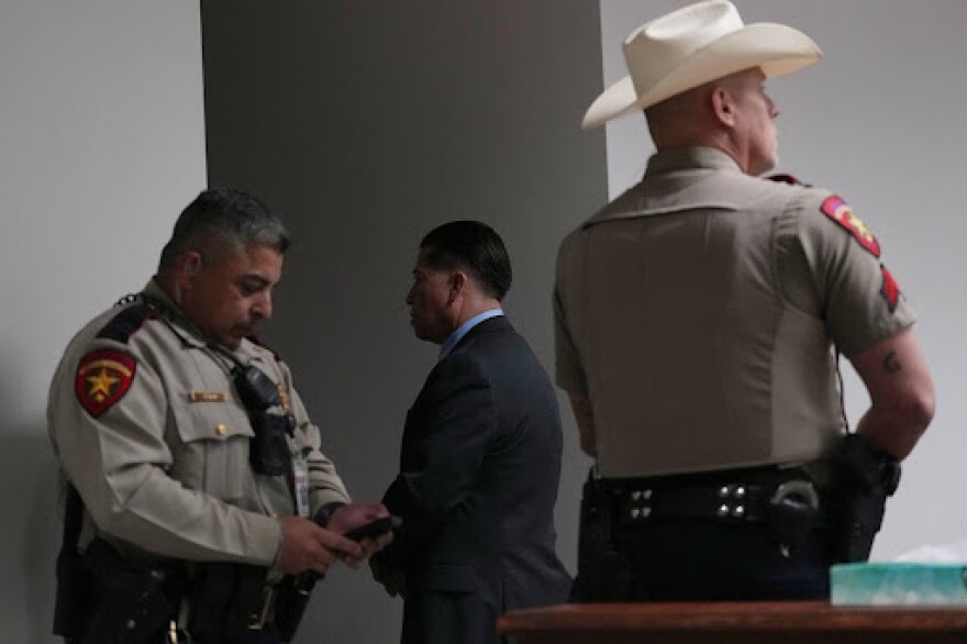 Former Uvalde school district police officer Adrian Gonzales, center, leaves the courtroom during a break at the Nueces County Courthouse in Corpus Christi, Texas, Tuesday, Jan. 6, 2026.