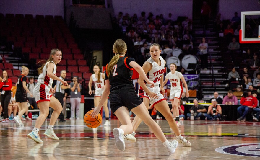 Girls high school basketball players inside an arena