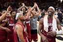 Miami Heat center Bam Adebayo, right, celebrates with teammates after he scored 83 points