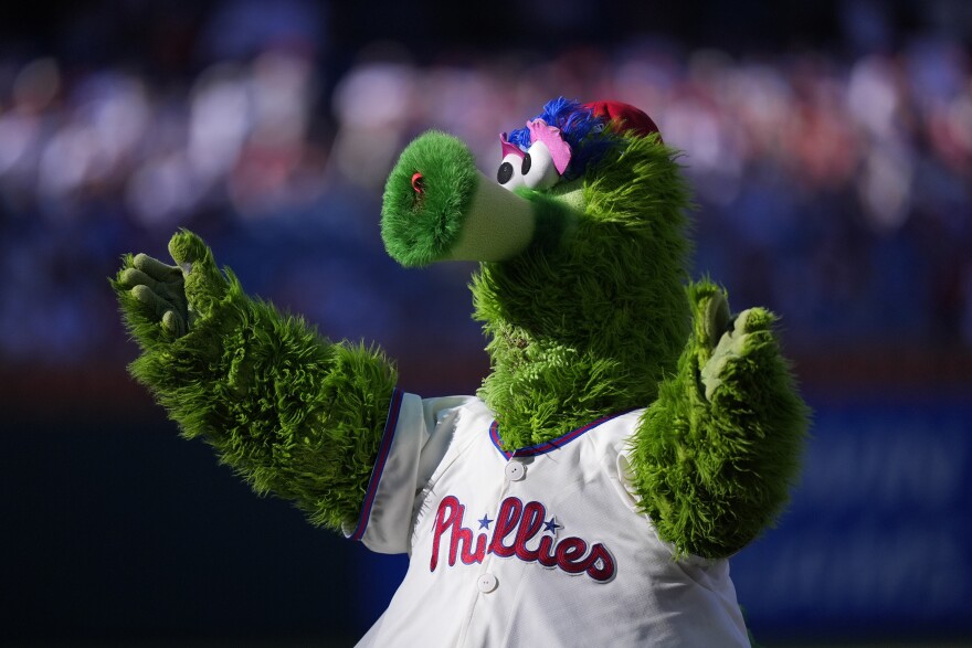 Philadelphia Phillies mascot, the Phillie Phanatic, performs before Game 2 of a baseball NL Division Series against the New York Mets, Sunday, Oct. 6, 2024, in Philadelphia. (AP Photo/Chris Szagola)