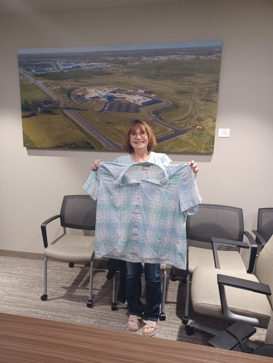 Ellen Bremer of Monett holds a shirt she used to wear before she lost nearly 90 pounds and lowered her A1C level