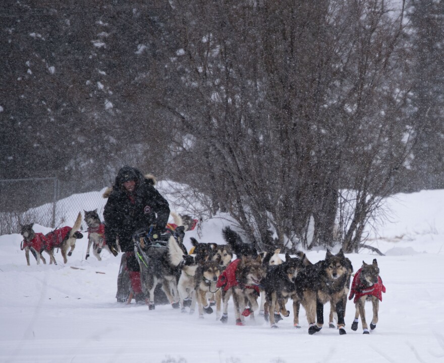 Jason Mackey leaves the Fort Yukon checkpoint with his son, Jason, behind him. (Herbert/KUAC)