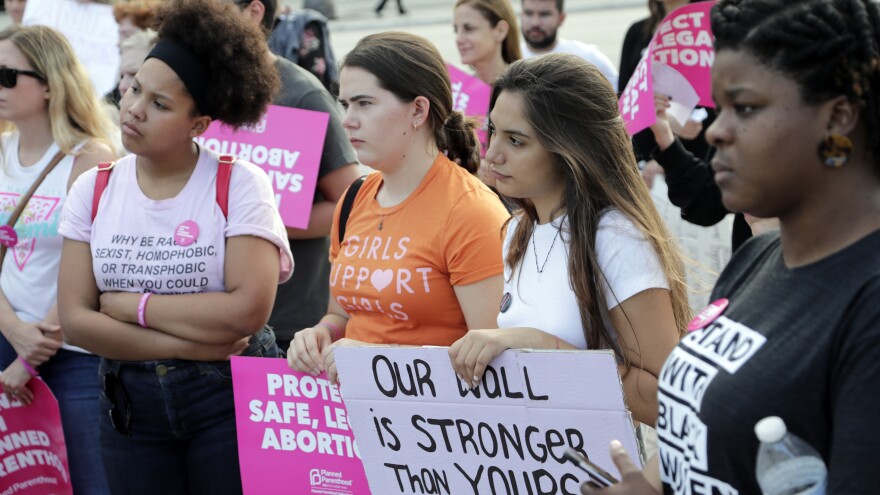 Demonstrators listen to speeches during a rally in support of abortion rights on Thursday in Miami. [Lynne Sladky / AP]