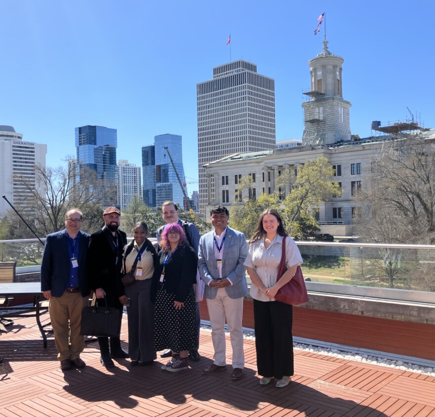 Josh Azriel - with students Jonathan Walker, Yahinness Lum, Grace Steele, Brandon Denley (behind Grace), Zach Lewis and Kayelyn McCaslin - standing in front of the Tennessee State Capitol at the Cordell Hull State Office Building.