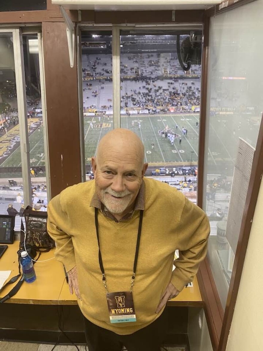 Jack Nokes stands in Wyoming Cowboys gear at the window of the War Memorial Stadium press box.