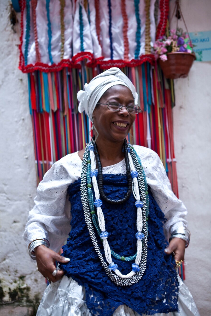 A Candomblé practitioner gets ready for the party outside the temple.