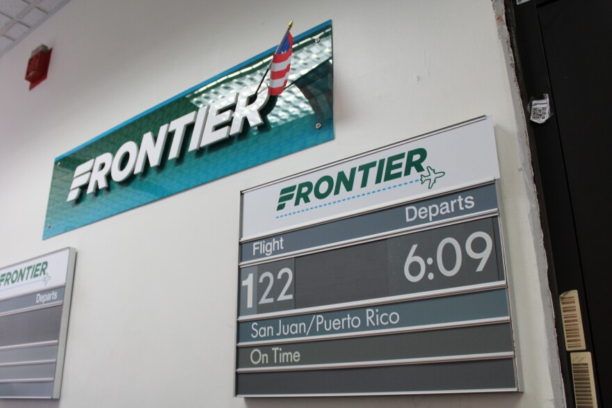 Frontier Airlines sign announcing flight between Cleveland and San Juan