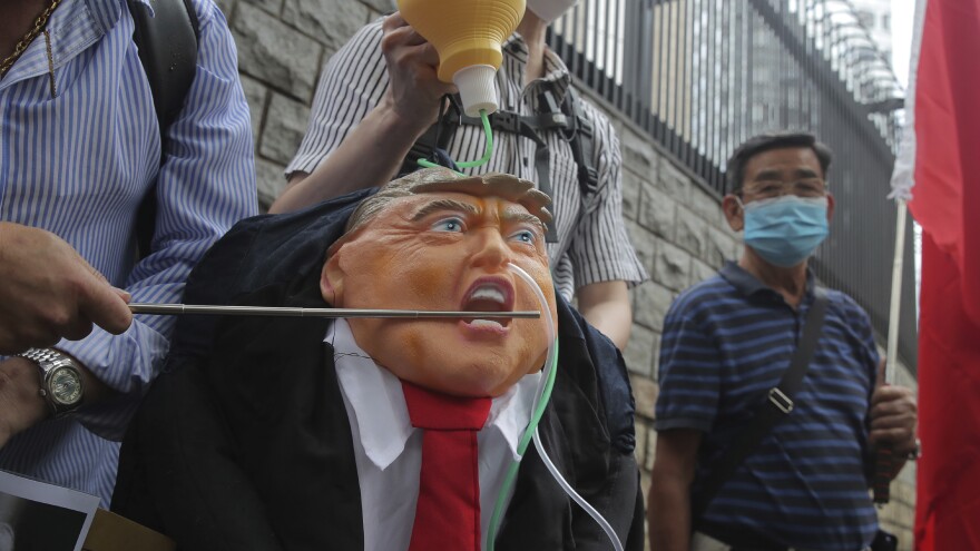 Demonstrators strike an effigy of President Trump outside the U.S. Consulate in Hong Kong during a May protest, following Trump's executive order aimed at revoking visas of Chinese nationals studying in the United States.