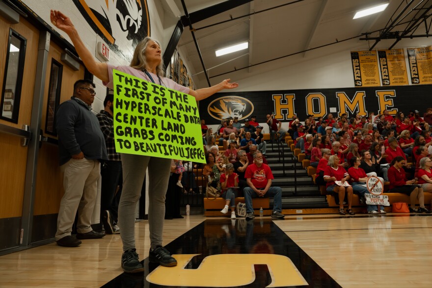 Michele Lococo, left, joins hundreds of Festus residents in opposing a plan to develop a large-scale data center in the community on Monday night.