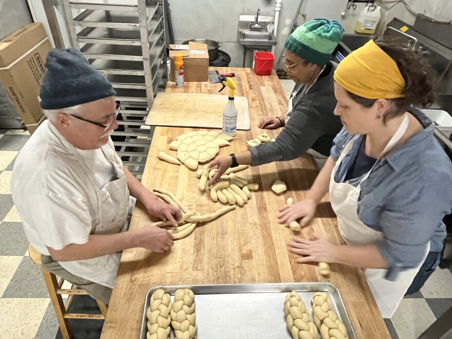 Tom Quinn (left), Anna Hanau (front right) and Jenny SoLis prep challah on Jan. 28, 2026, at Malek's Bakery in Brighton.