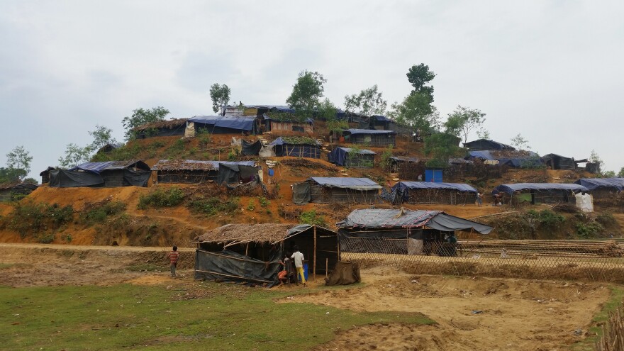 Small huts have been scraped out of the hillsides of the Balukali camp. Homes have blue plastic sheeting for walls, and roofs that are held together by thin strips of bamboo.