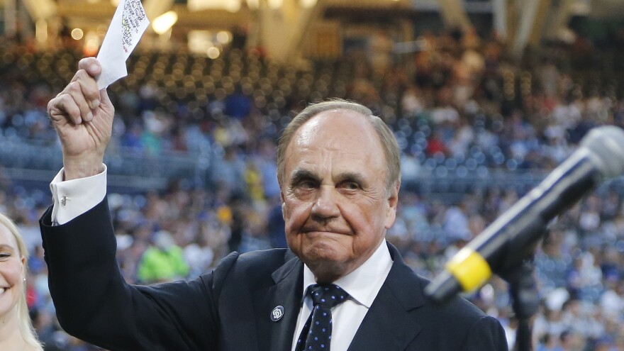 San Diego Padres broadcaster Dick Enberg waves to the crowd at a retirement ceremony prior to the Padres final home baseball game of the season on Sept. 29, 2016, in San Diego.