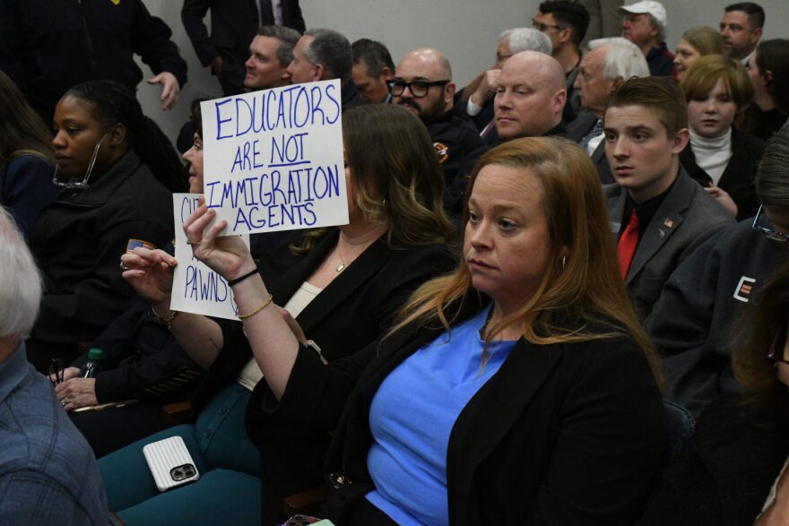 Protesters crowd a House committee hearing on a slew of immigration bills in March 2026.