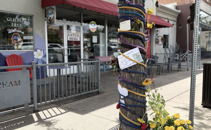A tree covered in decorations on a sidewalk