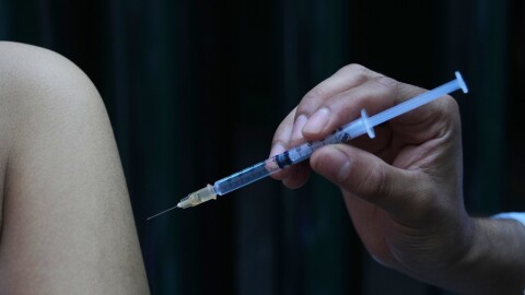 A health worker administers a dose of the measles vaccine outside a public hospital in Mexico City, Wednesday, Feb. 4, 2026.