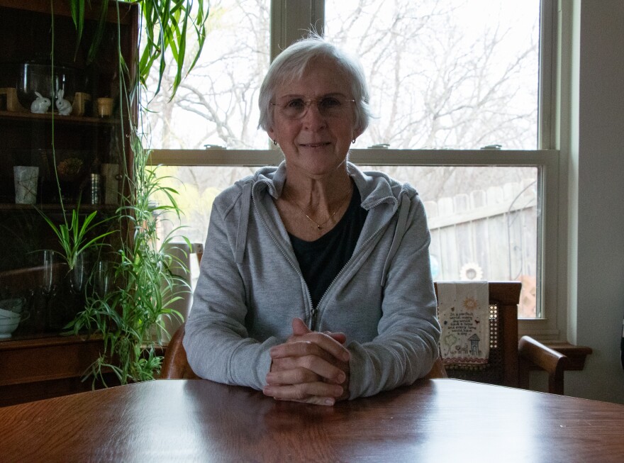 Mary Langley sits at her dining table in her home in Stillwater.