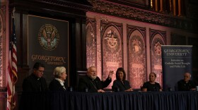 In this photo from September, the archbishop of Miami, Thomas Wenski, raises his hand while addressing a crowd during a panel on immigration at Georgetown University in Washington, Thursday, Sept. 11, 2025. (AP Photo/Luis Andres Henao,File)