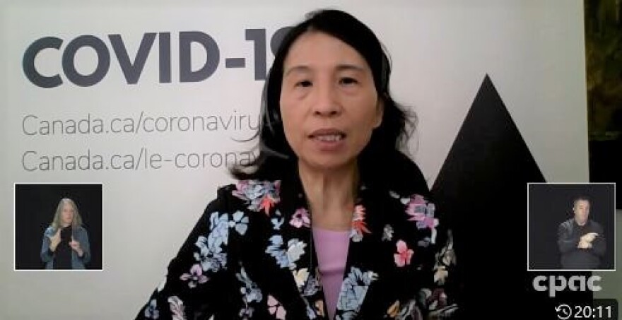 Dr. Theresa Tam appears during a COVID-19 briefing Feb. 4, wearing a black flowered jacket in front of a black and white "COVID-19" background.