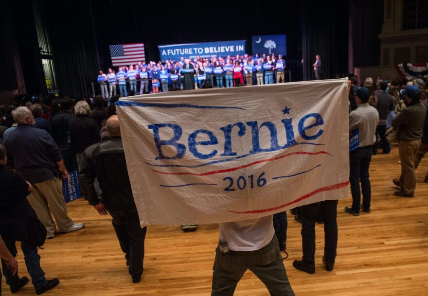 A supporter of Democratic presidential candidate Bernie Sanders holds up a sign as Sanders addresses a rally at the Township Auditorium in Columbia, South Carolina.