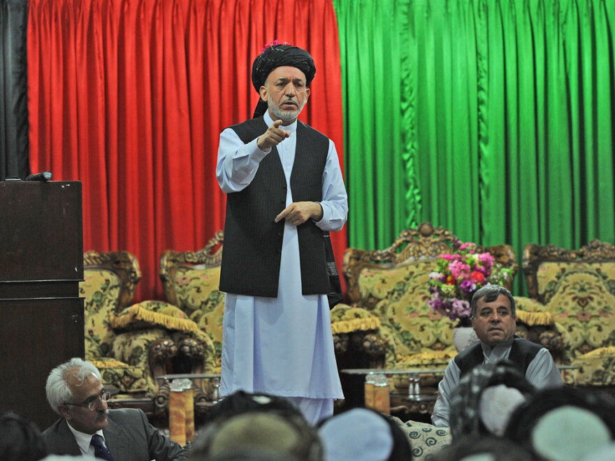 Afghan President Hamid Karzai speaks at a meeting with tribal leaders Sunday in Kandahar. Karzai appealed to hundreds of tribal and religious leaders at the <em>jirga </em>to support a major operation in their southern province, the heartland of a Taliban insurgency.